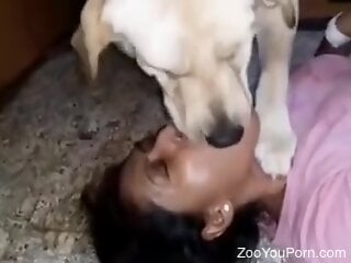 Mulatto woman sexy kisses a real dog