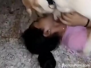 Mulatto woman sexy kisses a real dog